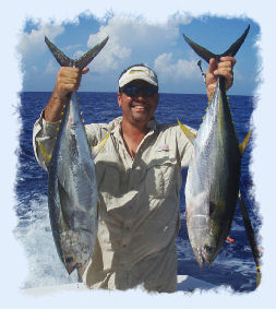 Key West offshore fishing guide holding 2 yellow fin tuna.