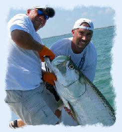 Fisherman holding a Tarpon caught on a Key West fishing charter.
